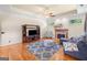 Charming living room with hardwood floors, fireplace, large windows, and a blue sofa at 226 Euharlee Five Forks Rd, Kingston, GA 30145