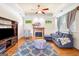 Inviting living room features a fireplace, hardwood flooring, and a comfortable blue sofa at 226 Euharlee Five Forks Rd, Kingston, GA 30145