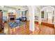 Cozy living room with fireplace, hardwood floors, large windows, and a blue sofa at 226 Euharlee Five Forks Rd, Kingston, GA 30145