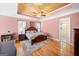 Main bedroom with hardwood floors, ceiling fan, tray ceiling, ensuite bathroom, and fireplace at 226 Euharlee Five Forks Rd, Kingston, GA 30145
