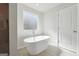 A bright bathroom with a modern standalone tub and a view from the window at 257 Orwell Drive Lot 48 # 48, Social Circle, GA 30025