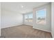 A spacious bedroom featuring plush carpeting, three windows, and neutral paint at 257 Orwell Drive Lot 48 # 48, Social Circle, GA 30025