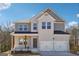 Charming two-story home with a welcoming front porch and a two-car garage, offering curb appeal at 257 Orwell Drive Lot 48 # 48, Social Circle, GA 30025
