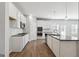 Kitchen with white cabinets, granite countertops, stainless steel appliances, and wood floors at 257 Orwell Drive Lot 48 # 48, Social Circle, GA 30025