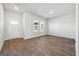 Living room with wood flooring, neutral walls, a window, and a white front door at 257 Orwell Drive Lot 48 # 48, Social Circle, GA 30025