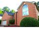 Lovely exterior elevation featuring brick facade, well manicured landscaping, and an attached garage at 122 Carolinas Way, Fayetteville, GA 30215