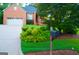 Lovely brick exterior, with manicured landscaping and attached garage, exudes curb appeal at 122 Carolinas Way, Fayetteville, GA 30215