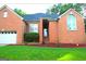Charming all brick home featuring an attached garage and professionally landscaped yard at 122 Carolinas Way, Fayetteville, GA 30215