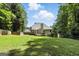 Expansive backyard with a wooden fence, a large deck, and plenty of space for outdoor activities at 136 Barrington Grange Dr, Sharpsburg, GA 30277