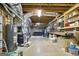 Unfinished basement with exposed ductwork, shelving, and a glimpse of a seating area in the background at 136 Barrington Grange Dr, Sharpsburg, GA 30277