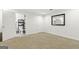 Finished basement includes a room, a door, and a view of the adjacent bathroom at 136 Barrington Grange Dr, Sharpsburg, GA 30277