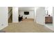 Finished basement area with carpet, a desk, stairs and a door leading to a bathroom at 136 Barrington Grange Dr, Sharpsburg, GA 30277