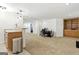 Open basement area with a granite countertop, carpeted flooring, and built-in shelving in the distance at 136 Barrington Grange Dr, Sharpsburg, GA 30277