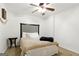 Cozy bedroom with a ceiling fan and a comfortable bed dressed with pillows and a blanket at 136 Barrington Grange Dr, Sharpsburg, GA 30277