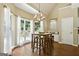 Bright breakfast nook with large windows, chandelier, and a cozy seating area, perfect for enjoying morning meals at 136 Barrington Grange Dr, Sharpsburg, GA 30277