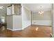 Open-concept dining room with hardwood flooring, chandelier, and stairs to the upper level at 136 Barrington Grange Dr, Sharpsburg, GA 30277