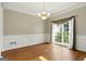 Bright dining area features a large window, hardwood floors, decorative molding and a chandelier at 136 Barrington Grange Dr, Sharpsburg, GA 30277