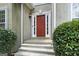 Close up of the front door with sidelights and beautiful landscaping at 136 Barrington Grange Dr, Sharpsburg, GA 30277
