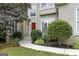 Inviting front entrance with a red door, sidelights, and mature landscaping at 136 Barrington Grange Dr, Sharpsburg, GA 30277