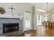 Charming living room with stone fireplace leading to a sunny breakfast nook with large bay windows at 136 Barrington Grange Dr, Sharpsburg, GA 30277