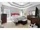 Tranquil main bedroom with tray ceilings, plush carpeting, and large windows offering plenty of natural light at 136 Barrington Grange Dr, Sharpsburg, GA 30277