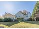 Spacious backyard view featuring a well-maintained lawn and mature trees at 214 Palette Ln, Peachtree City, GA 30269