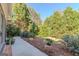 Backyard featuring a well-maintained lawn and landscaping with mature trees at 214 Palette Ln, Peachtree City, GA 30269