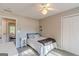Neutral bedroom with ceiling fan, closet, and natural light from en-suite doorway at 214 Palette Ln, Peachtree City, GA 30269