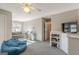 Bright bonus room with carpet, furniture, a ceiling fan, and built-in storage at 214 Palette Ln, Peachtree City, GA 30269