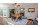 Cozy dining room with a fireplace, elegant china cabinet, and a classic wooden table setting for six at 214 Palette Ln, Peachtree City, GA 30269