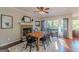 Cozy dining room with a brick fireplace, hardwood floors, and natural light from the windows at 214 Palette Ln, Peachtree City, GA 30269