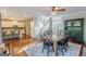 Open concept design showcasing the dining room, kitchen, and stairway, with natural light and hardwood flooring at 214 Palette Ln, Peachtree City, GA 30269