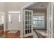 Open entryway leading to the front door and a home office with hardwood floors at 214 Palette Ln, Peachtree City, GA 30269