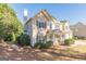 Two story home with a well manicured yard, a chimney, and mature landscaping at 214 Palette Ln, Peachtree City, GA 30269