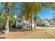 Two story home with a well manicured yard with mature trees and landscaping in a suburban setting at 214 Palette Ln, Peachtree City, GA 30269