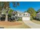 Charming two-story home with a two-car garage, blue front door, and well-maintained landscaping at 214 Palette Ln, Peachtree City, GA 30269