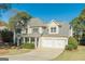 Charming two-story home with a two-car garage, blue front door, and well-maintained landscaping at 214 Palette Ln, Peachtree City, GA 30269