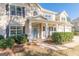 Charming front porch featuring a light blue door, decorative wreath, and cozy seating area with chairs at 214 Palette Ln, Peachtree City, GA 30269