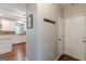 Hallway view of the white kitchen cabinets, granite countertops, and hardwood floors at 214 Palette Ln, Peachtree City, GA 30269