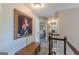 The 2nd story hall leads to the bedrooms with a painting on the wall and a view of the bedroom inside at 214 Palette Ln, Peachtree City, GA 30269