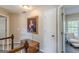 The 2nd story hall leads to the bedrooms with a painting on the wall and a view of the bedroom inside at 214 Palette Ln, Peachtree City, GA 30269