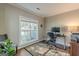 Comfortable home office with a large window, hardwood floors, and ample workspace at 214 Palette Ln, Peachtree City, GA 30269