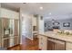 Bright kitchen with stainless appliances and granite counters opens to dining and living areas at 214 Palette Ln, Peachtree City, GA 30269