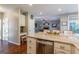 Bright kitchen features granite countertops, stainless steel appliances, and beautiful hardwood floors at 214 Palette Ln, Peachtree City, GA 30269