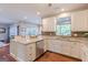 Bright kitchen with stainless steel appliances, granite countertops, and an open view to a sunny seating area at 214 Palette Ln, Peachtree City, GA 30269