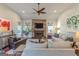 Spacious living room with a fireplace, ceiling fan, and plenty of natural light at 214 Palette Ln, Peachtree City, GA 30269