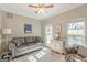 This living room features a comfortable sofa, chair, and two windows at 214 Palette Ln, Peachtree City, GA 30269