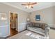 Cozy living room featuring a comfortable gray sofa and a ceiling fan for added comfort at 214 Palette Ln, Peachtree City, GA 30269