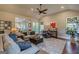 Cozy living room with plush seating, patterned rug, and backyard views through the large windows at 214 Palette Ln, Peachtree City, GA 30269