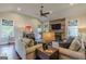 Inviting living room featuring a stone fireplace, mounted TV, and comfortable seating at 214 Palette Ln, Peachtree City, GA 30269